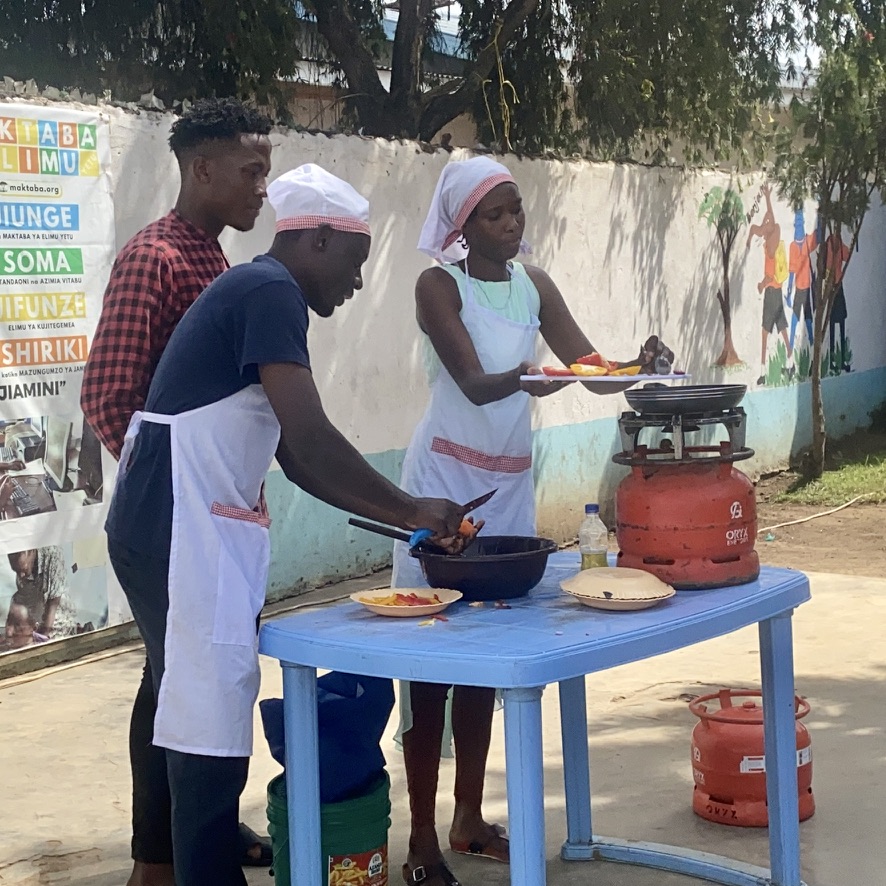 Community members learning practical cooking skills
