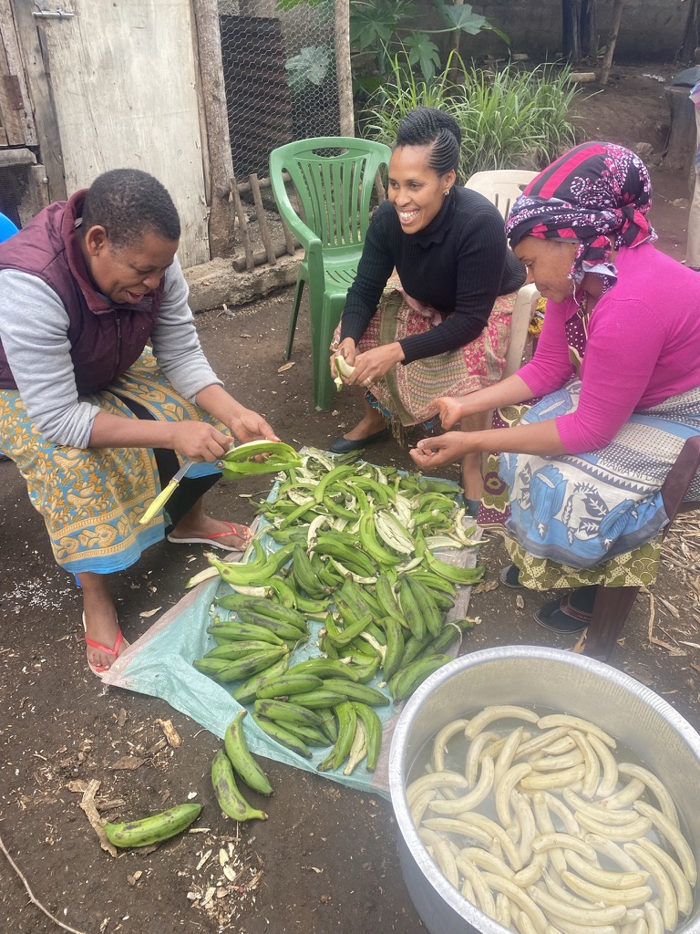 Women preparing food together in a community setting